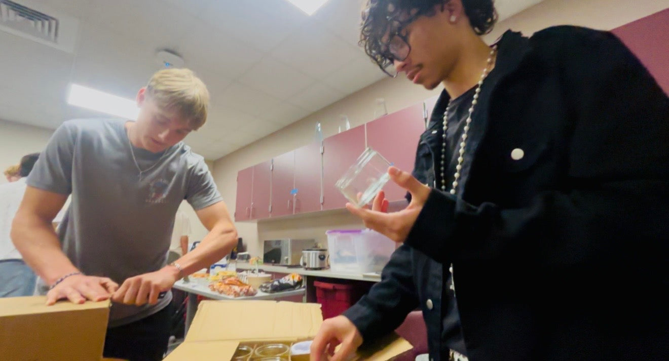 The Ascented team packing jars into boxes